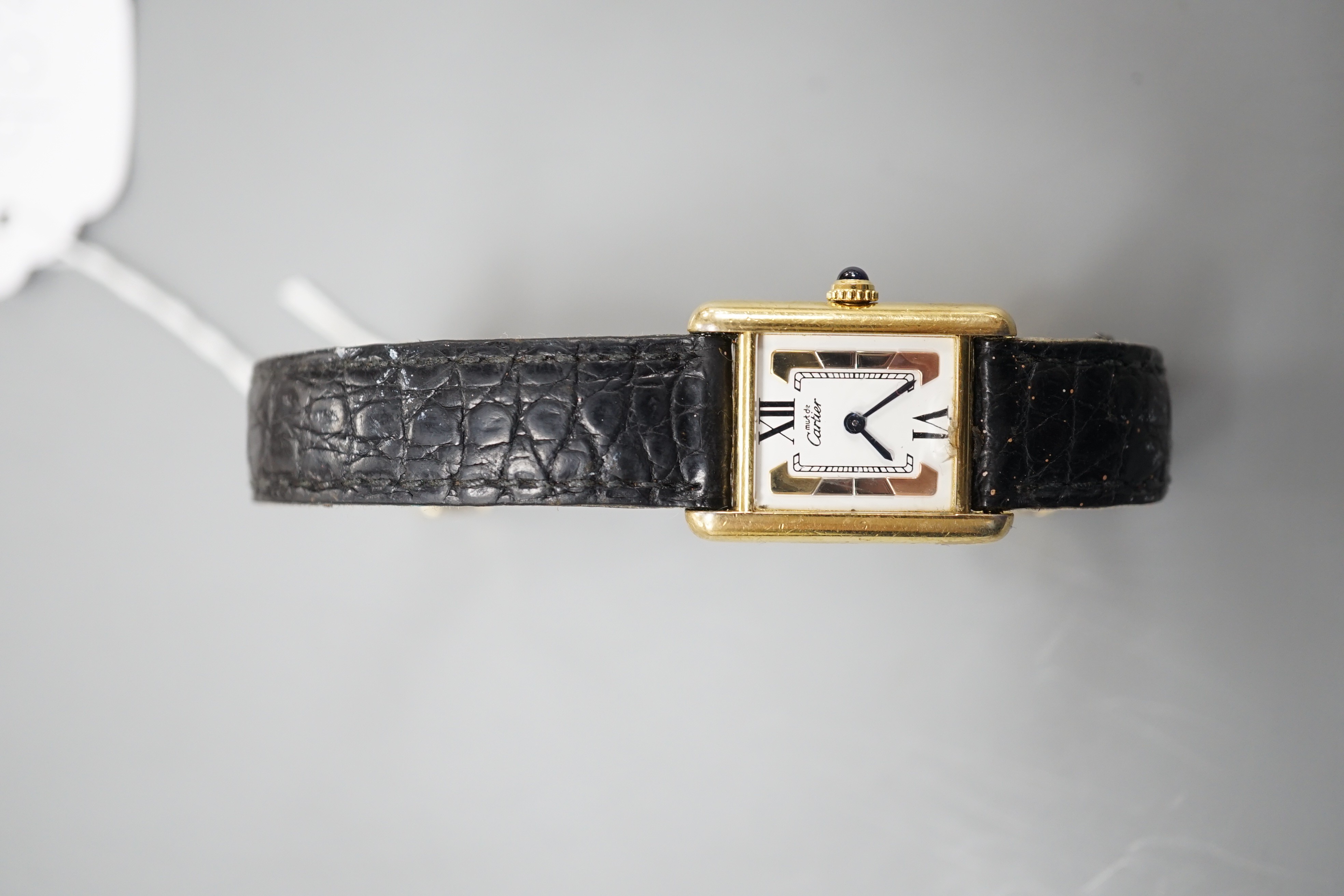 A lady's modern 925 gilt Must de Cartier rectangular quartz wrist watch, with three colour dial, on Cartier bracelet with gilt steel deployment clasp, no box or papers.